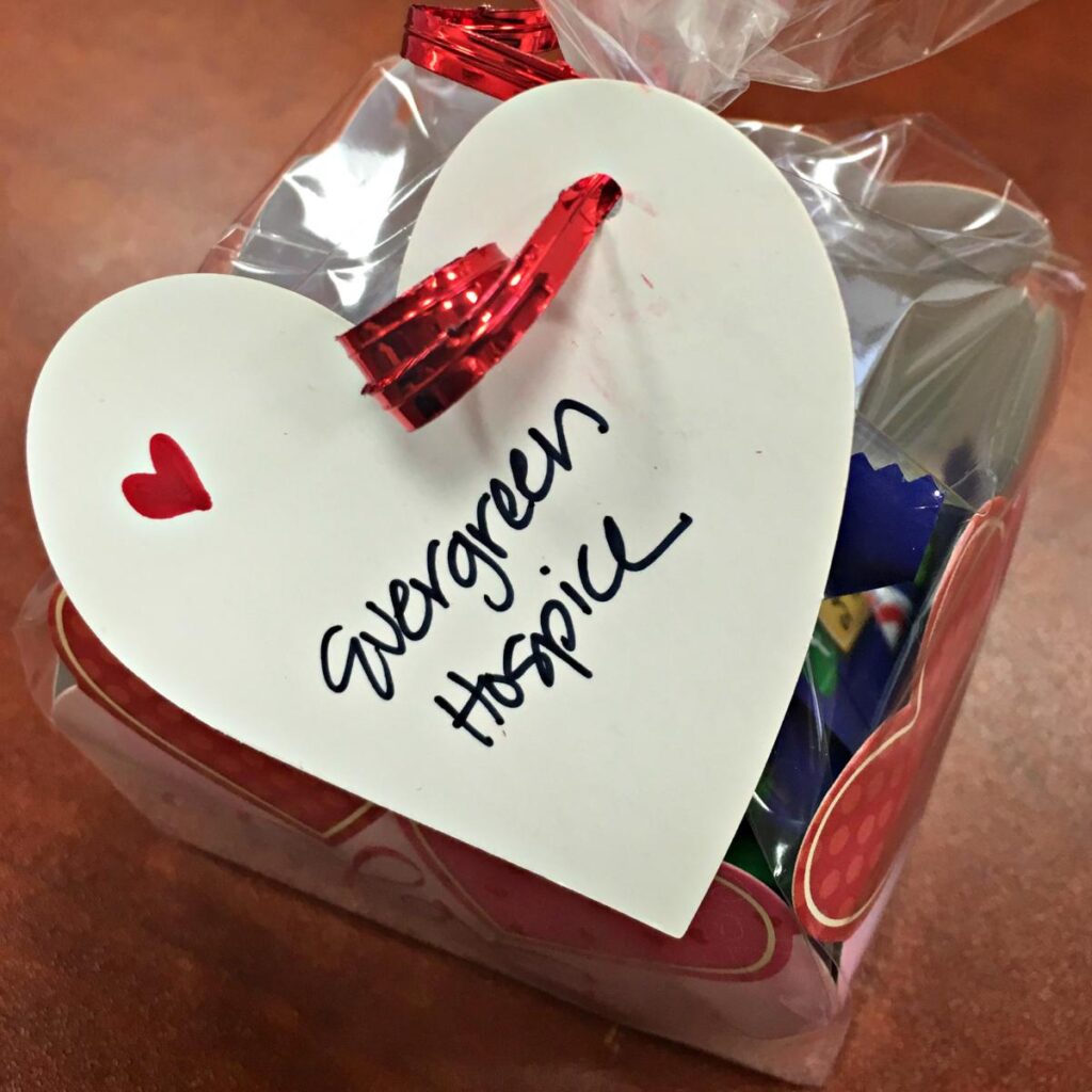 Gift box in the shape of a heart with Evergreen Hospice written on the lid.