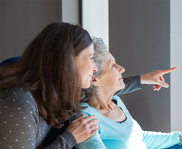 Adult Volunteer Visiting Elderly Woman